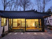江陵市Bow Hanok House的一座带屋顶温室的房子