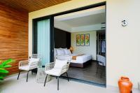 乌布Big Dragon Villas Ubud的一间卧室，里面有一张床、两把椅子和一张桌子