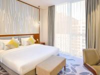 Grand Mercure Dubai City客房内的一张或多张床位
