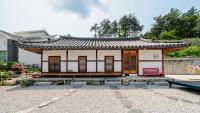 江陵市Gangneung ggabinejip hanok pension的院子里有一座亚洲式屋顶的小房子