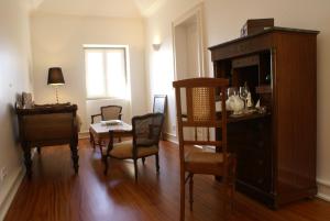 丰沙尔Quinta Paços do Lago的客厅配有桌椅和橱柜。