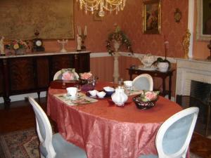塞内泰梅泽德尚布赫酒店的用餐室配有红色桌椅和壁炉