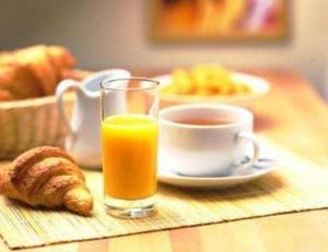 Mansigné拉铁勒斯奥立威酒店的一杯橙汁和一杯茶