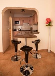 韦尔都勒博Casa das Flores的厨房配有柜台和2个酒吧凳
