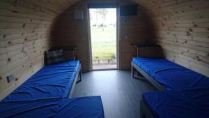 GlamisDrumshademuir Caravan & Camping Park的带窗户的客房内的两张床