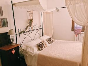 马利亚诺因托斯卡纳乐塔尔塔鲁胡B＆B住宿加早餐酒店的一间卧室配有带白色床单和枕头的床。