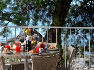 普尔萨诺Luxury Beach Villa Puglia Italy的阳台上摆放着食物盘的桌子