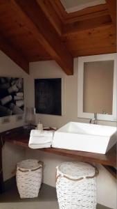博尔戈马内罗Relais Profumo di Vino的一间带水槽和两个柳条篮的浴室