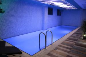 伊斯坦布尔里奥斯版酒店 的蓝色灯光的房间的游泳池