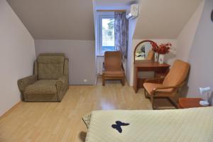 尤尔马拉Jurmala Guest House Markiza的一间卧室配有一张床、一把椅子和一张桌子