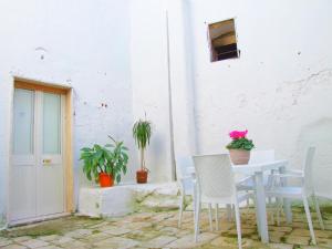 莱韦拉诺Casa Donna Lavinia的白色建筑前的桌椅