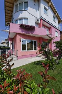 法瓦罗威尼托生态威尼斯公寓的粉红色和白色的房子,有院子