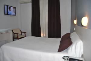 阿尔蒙德拉立窑Hotel Los Angeles的酒店客房,配有白色的床和椅子