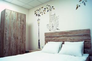 索契City Hostel的一间卧室配有一张带木制床头板的床