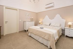 莫诺波利Casa Velia的卧室配有白色大床和梳妆台