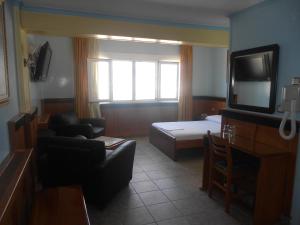 沃洛斯阿德米托斯酒店的客房设有床、沙发和电视。
