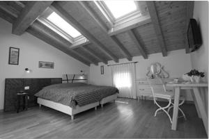 CastelgombertoBed & Breakfast Ai Cracchi的卧室配有一张床、一张书桌和窗户。