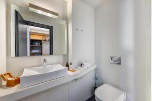埃尔莫波利斯Naves Suites的白色的浴室设有水槽和镜子