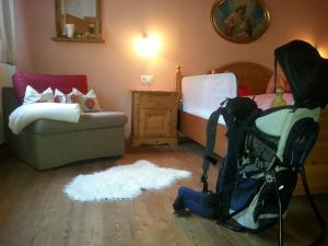 菲根Chalet Tyrol的一间带婴儿推车和床的客厅