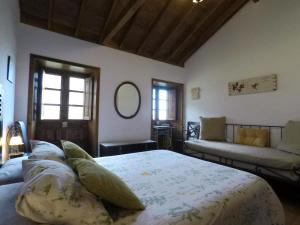 埃尔米瓜拉诺坎普乡村民宿的一间卧室配有一张床和一张沙发