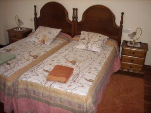 埃切贝里亚Pension Txomin Ostatua的一张带木制床头板和钱包的床