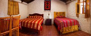 科塔卡奇Kallpa Wasi的一间卧室,配有两张床