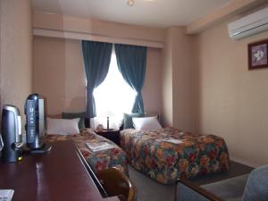 朝日市客栈酒店客房内的一张或多张床位