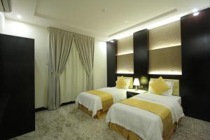 Qasr Rayana Aparthotel客房内的一张或多张床位