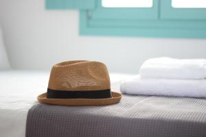 布拉卡Ploes Seaside Houses的坐在床上的帽子
