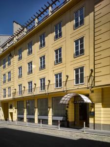 维也纳马利亚特雷西亚K+K酒店的街道上带阳台的黄色建筑