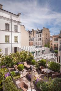 巴黎杜克圣西蒙酒店的一座带桌椅的屋顶露台和建筑