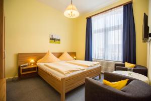 博尔库姆瓦尔德泽格拉芙酒店的配有一张床和一把椅子的酒店客房