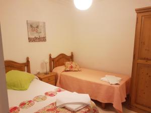 阿雷纳尔登卡斯特尔贝利萨斯公寓的小型客房配有两张床和两张桌子。