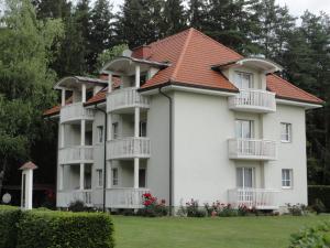 圣卡尼兹弗瑞恩瓦豪昂罗盖特斯酒店的一座白色的大建筑,有红色的屋顶