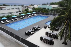 卢甘维尔Luganvilla Business Hotel and Restaurant的享有带桌椅的游泳池的顶部景致
