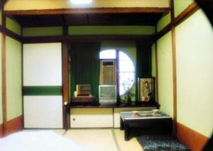 东京塔玛日式旅馆的一间设有一张桌子和一面镜子的房间