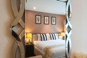 拉威海滩KR头衔海滩公寓酒店的一间卧室配有一张床和镜子