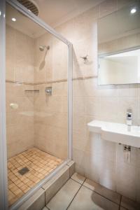 东伦敦Santorini Guesthouse的带淋浴和盥洗盆的浴室
