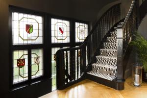 斯特拉斯堡十五号精品酒店 的走廊上设有彩色玻璃窗的楼梯
