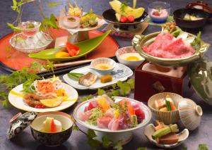 热海优米诺哈娜酒店的一张桌子上放着许多盘子的食物