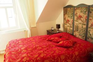 陶努斯的孔宁斯泰因Luxus Residenz Königstein的卧室内的红色床和红色枕头