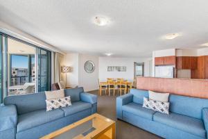 穆卢拉巴蒙特拉木陆拉巴海滩酒店的一间带蓝色沙发的客厅和一间厨房