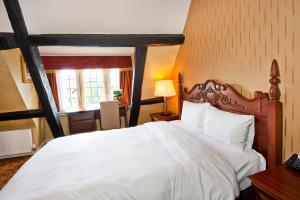 班伯里Cromwell Lodge Hotel by Greene King Inns的卧室设有一张白色大床和一扇窗户。