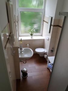 罗斯托克费舍尔昂旅馆的浴室设有窗户、水槽和卫生间。