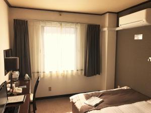 Hotel Tomakomai Green Hills客房内的一张或多张床位