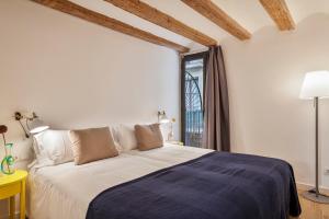 巴塞罗那埃斯帕特里亚巴塞罗那市内公寓的一间卧室设有一张大床和一个窗户。