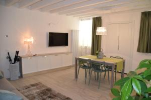 维罗纳Verona White Lodge的客厅配有桌子和墙上的电视
