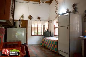 科韦尼亚斯Hostal Roldan的带冰箱的厨房和客房内的一张床