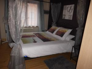克诺克－海斯特't Eenvoud - Logies的一间卧室配有一张带白色床单的床和一扇窗户。