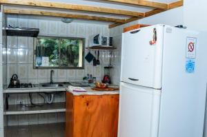 安加罗阿Cabañas MANA NUI INN的厨房配有白色冰箱和水槽